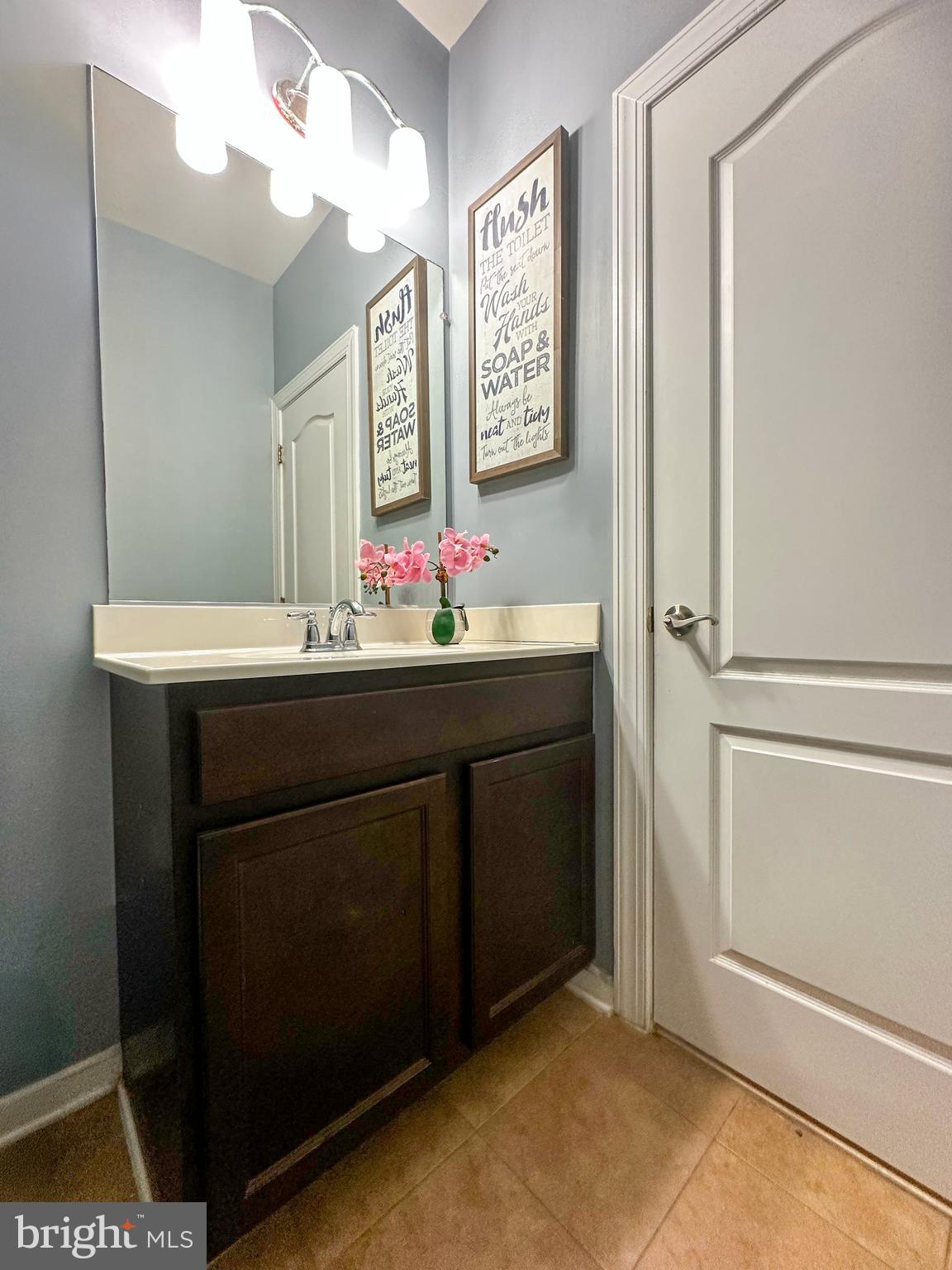 7444 Riding Meadow Way Manassas, VA 20111 - Photo 16 of 36 a bathroom with a sink vanity and a mirror