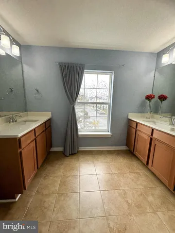 a kitchen with a sink a stove cabinets and a window