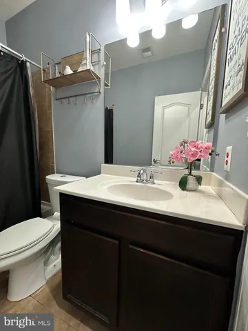 a bathroom with a sink vanity mirror and toilet