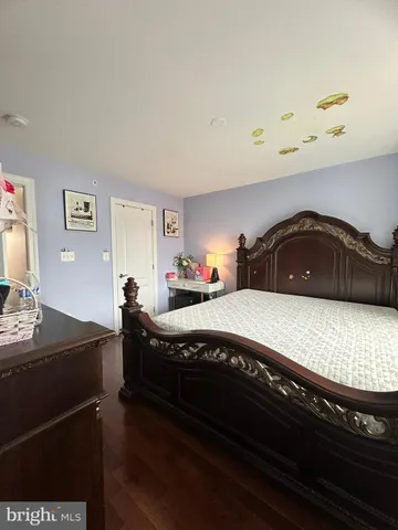 a bedroom with a bed and a desk