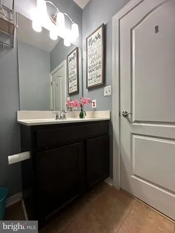 a bathroom with a sink vanity and a mirror