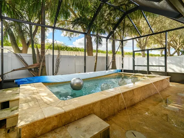a view of swimming pool with a patio and a yard