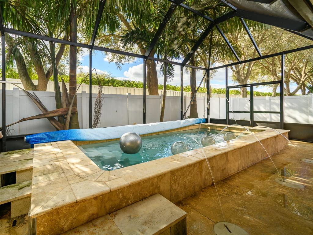 a view of swimming pool with a patio and a yard