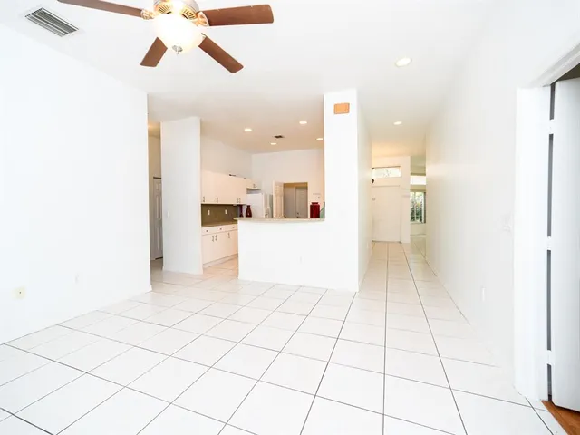 a view of a kitchen with a sink and cabinets