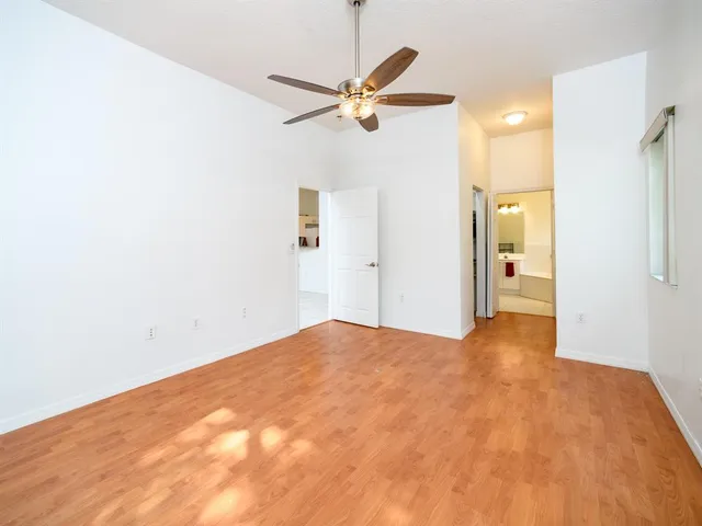a view of a hallway with a ceiling fan