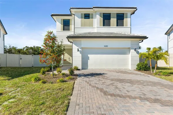 a front view of a house with a yard and garage
