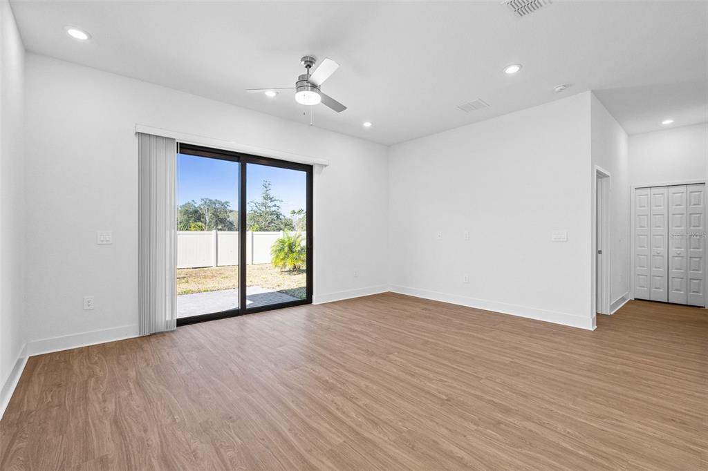 14413 Stellar Place Lakewood Ranch, FL 34202 - Photo 13 of 44 a view of an empty room with wooden floor and a window