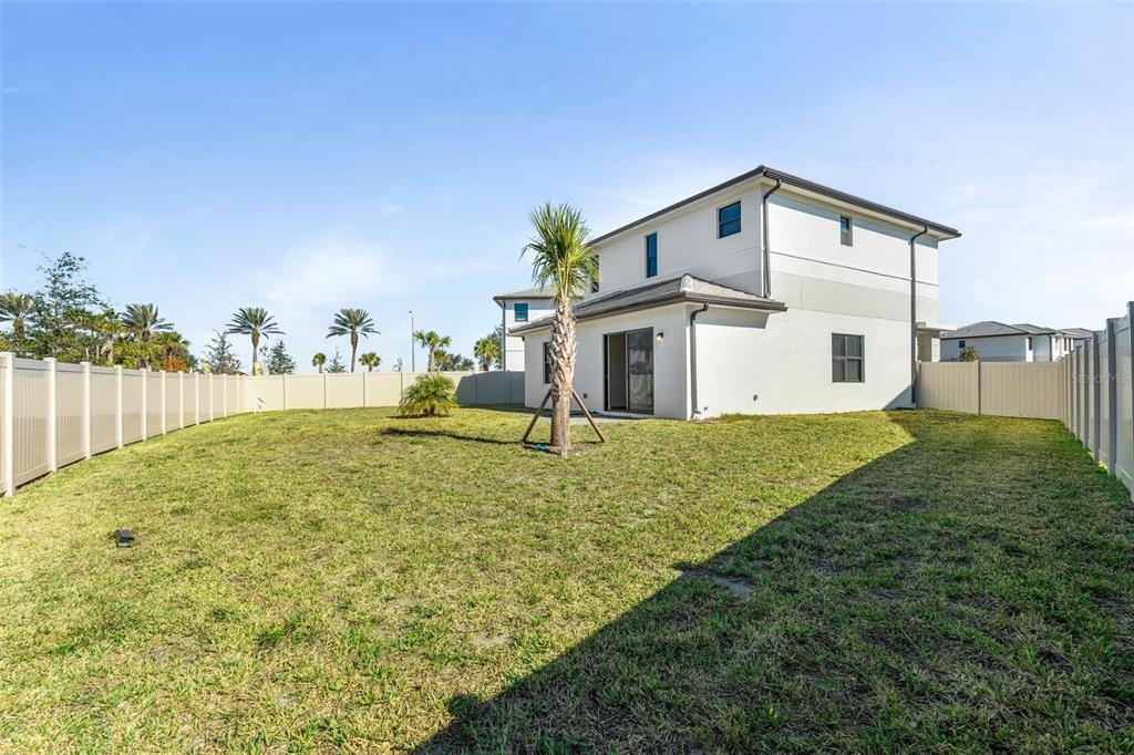 14413 Stellar Place Lakewood Ranch, FL 34202 - Photo 16 of 44 a view of an house with backyard and trees