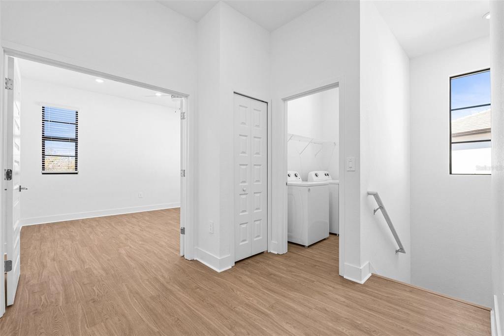 14413 Stellar Place Lakewood Ranch, FL 34202 - Photo 23 of 44 an empty room with wooden floor and windows