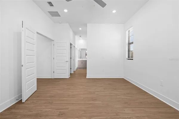 an empty room with wooden floor and closet
