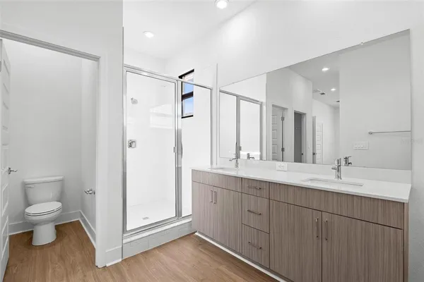 a spacious bathroom with a double vanity sink mirror and toilet