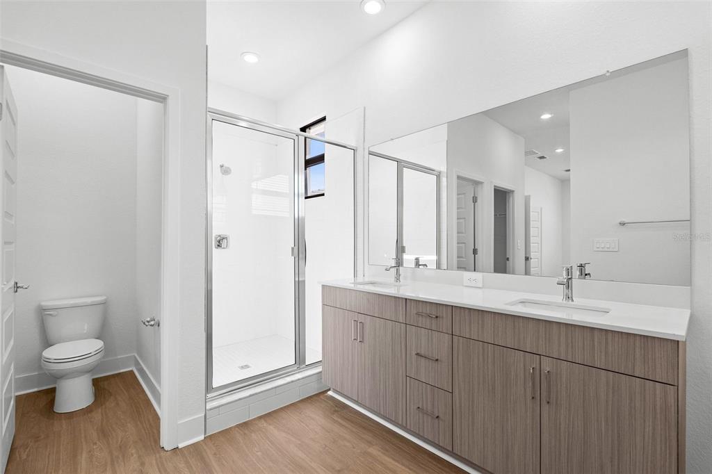 14413 Stellar Place Lakewood Ranch, FL 34202 - Photo 29 of 44 a spacious bathroom with a double vanity sink mirror and toilet