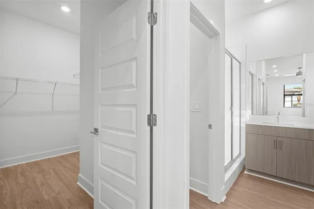 a view of a hallway with closet and wooden floor