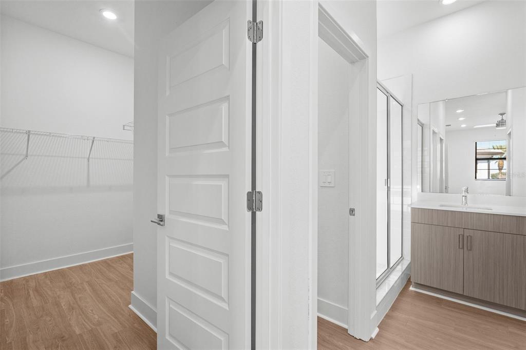 14413 Stellar Place Lakewood Ranch, FL 34202 - Photo 30 of 44 a view of a hallway with closet and wooden floor