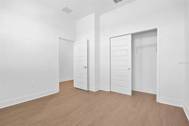 an empty room with wooden floor