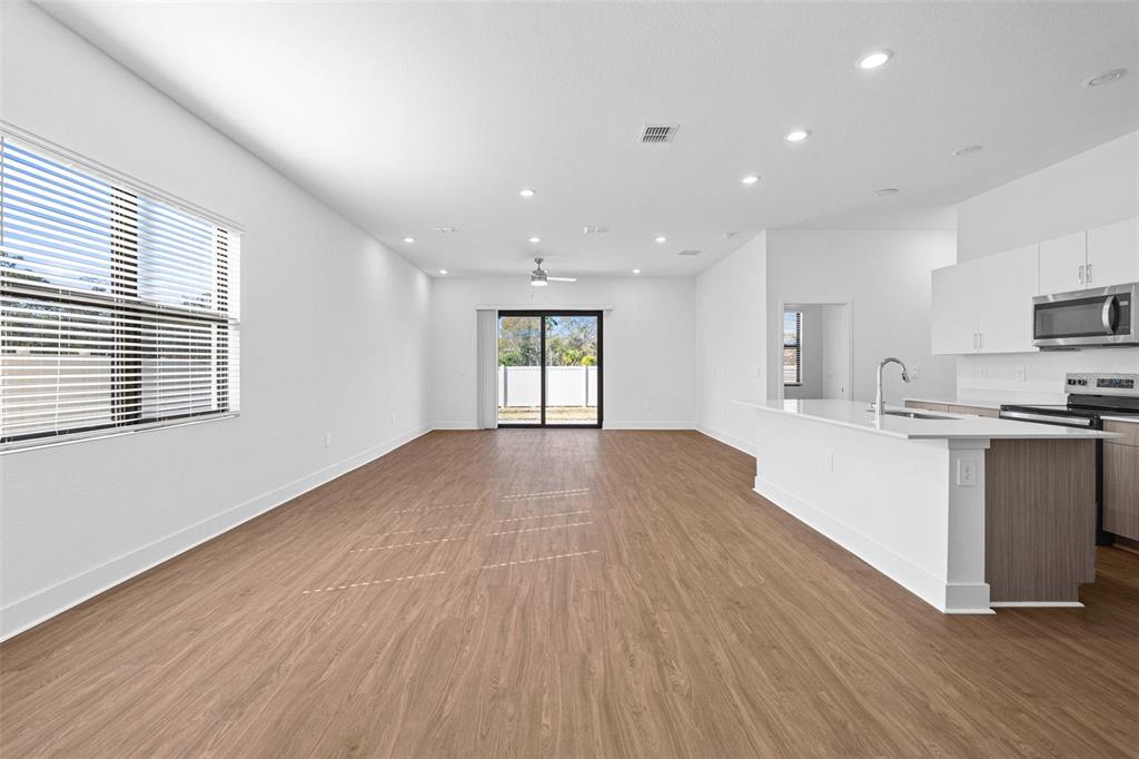 14413 Stellar Place Lakewood Ranch, FL 34202 - Photo 5 of 44 a view of kitchen with wooden floor and electronic appliances