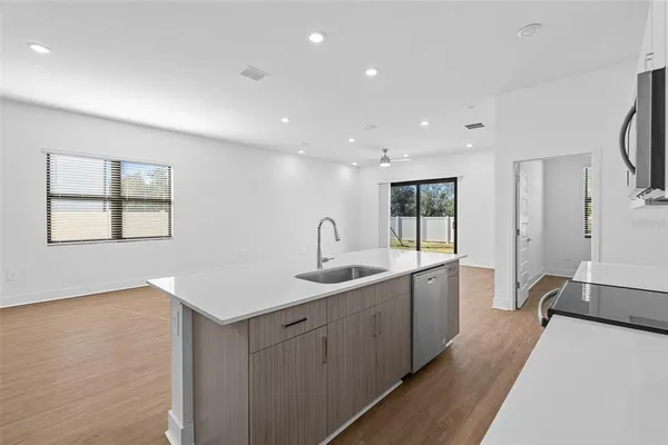 a kitchen with sink and mirror