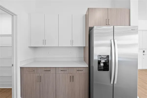 a kitchen with metallic refrigerator freezer and a dishwasher