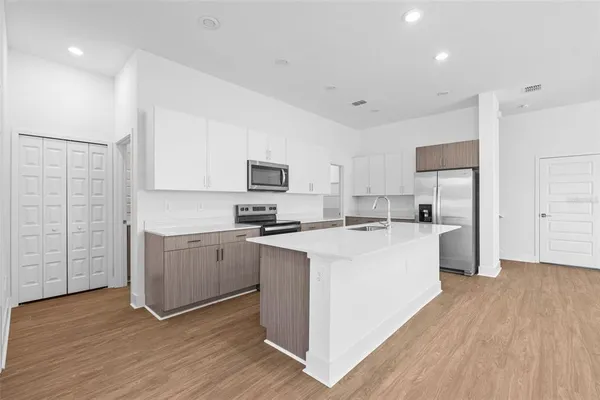 a kitchen with white cabinets and white appliances