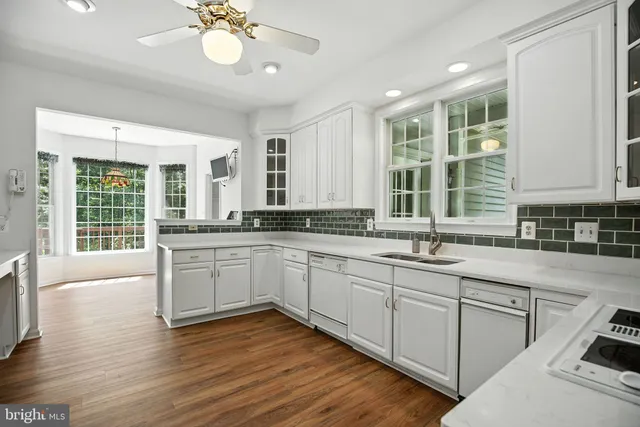 a kitchen with a sink cabinets and window