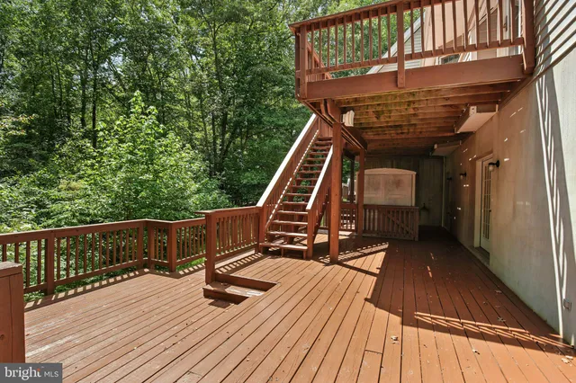 a view of balcony with wooden floor and fence