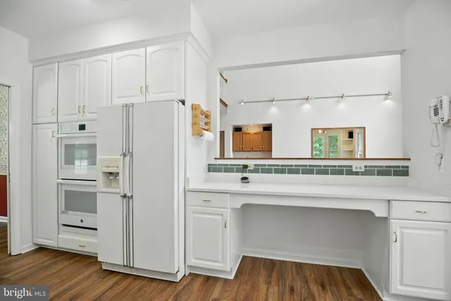 a kitchen with cabinets and a refrigerator