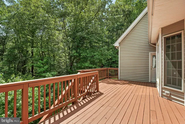 a view of a wooden deck with a yard