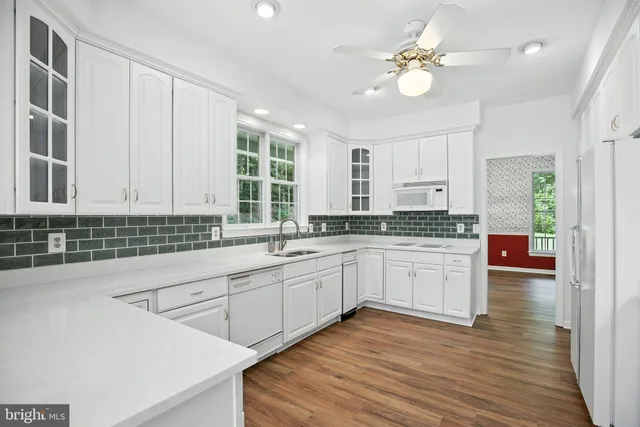 a kitchen with a sink cabinets and window