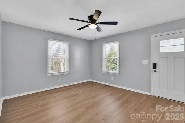 wooden floor in an empty room with a window