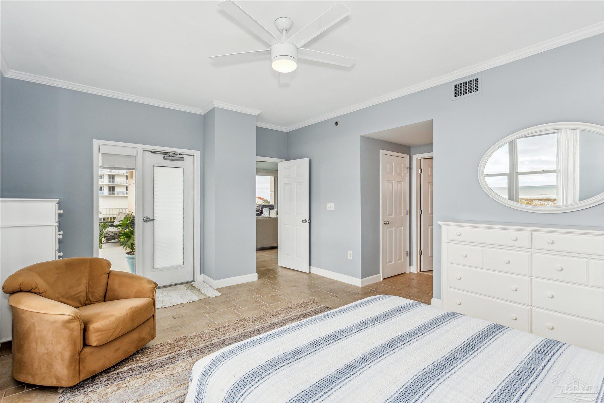 800 Fort Pickens Road, Unit 204 Pensacola Beach, FL 32561 - Photo 24 of 45 a bedroom with a bed and a couch