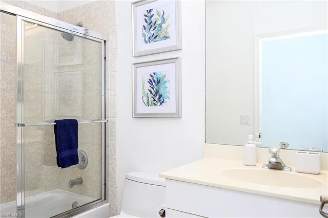 a bathroom with a shower a toilet and a shower