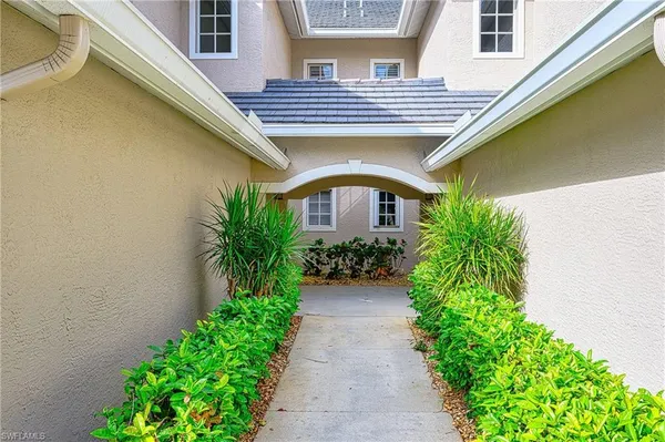 a front view of a house with plants