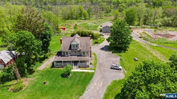 an aerial view of a house with yard swimming pool and outdoor seating