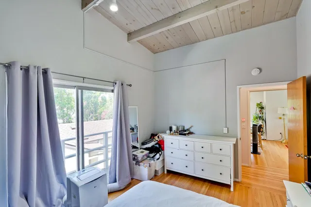 a living room with furniture a chandelier and a wooden floor
