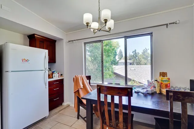 a kitchen with stainless steel appliances granite countertop a stove top oven a sink dishwasher and a refrigerator