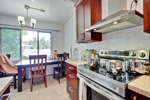 a kitchen with a stove a sink and a microwave