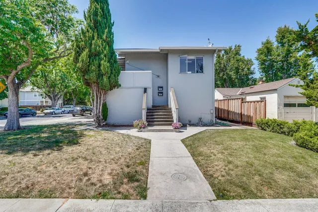 a bedroom with bed and a chandelier