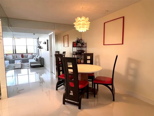 a dining room with furniture and chandelier
