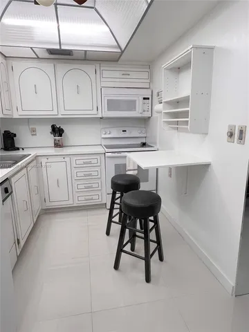 a kitchen with stainless steel appliances cabinets a sink and a stove