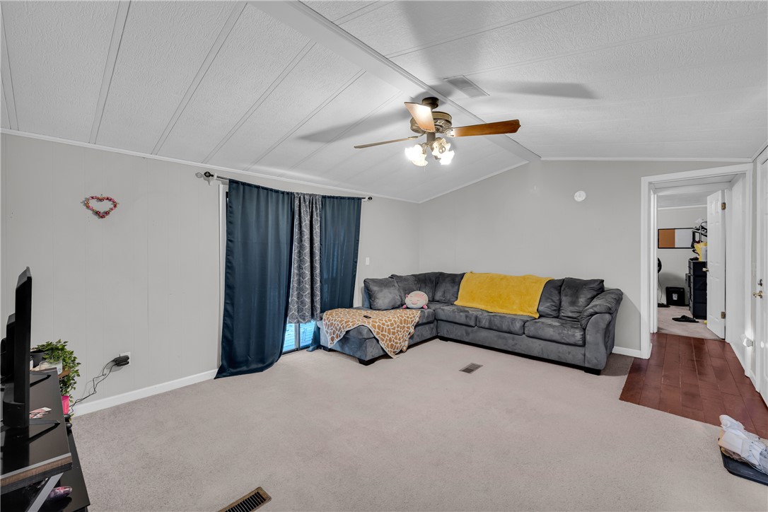 150 Newberry Road Walhalla, SC 29691 - Photo 4 of 47 Step into this comfortable living room featuring soft carpeting and a classic ceiling fan.