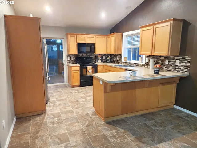 a view of a kitchen with a sink and cabinets
