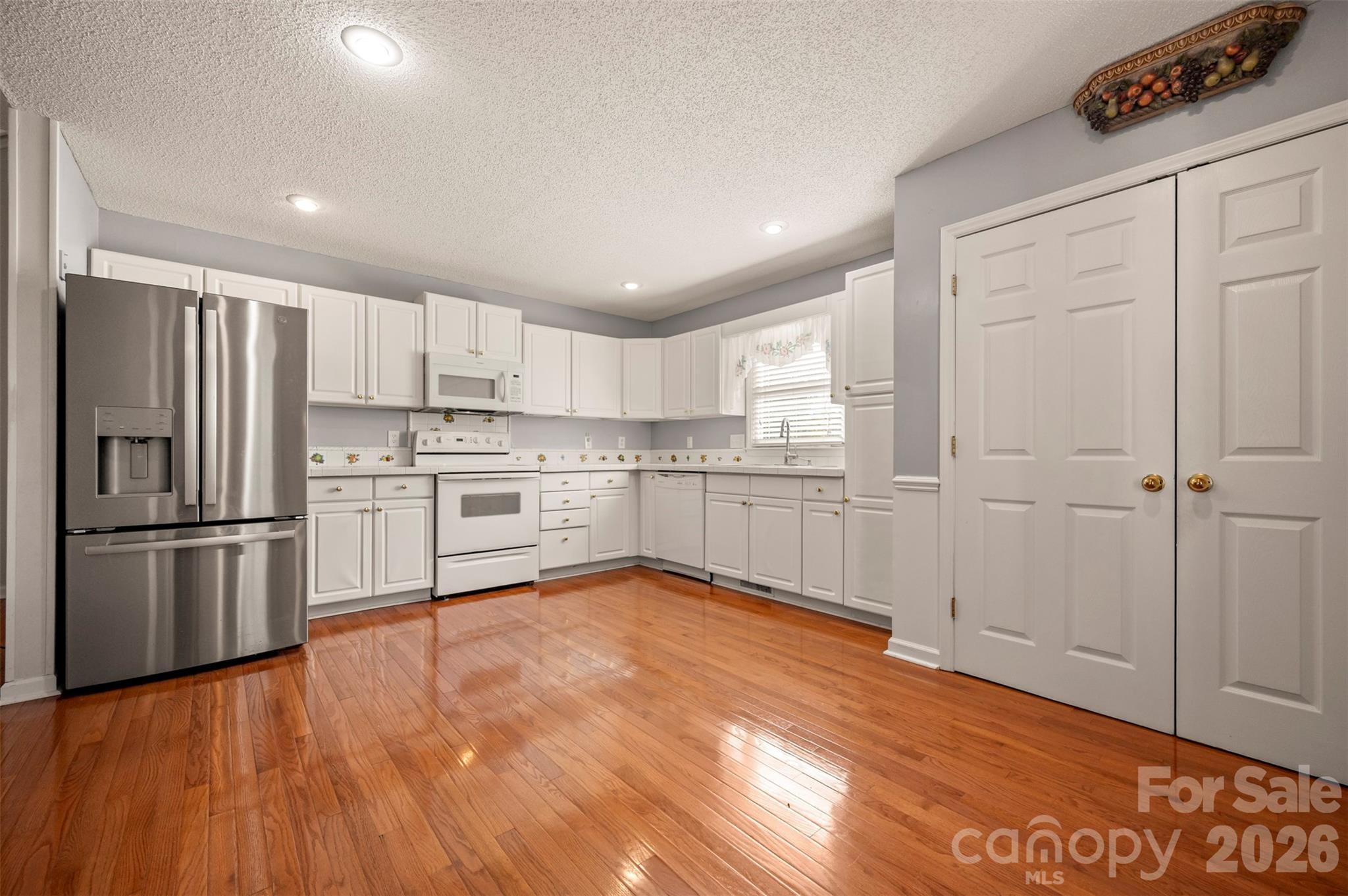 506 Pleasant Street Spindale, NC 28160 - Photo 11 of 42 a kitchen with stainless steel appliances granite countertop a refrigerator sink and white cabinets
