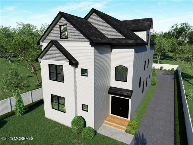 a white house with a small yard and a large window