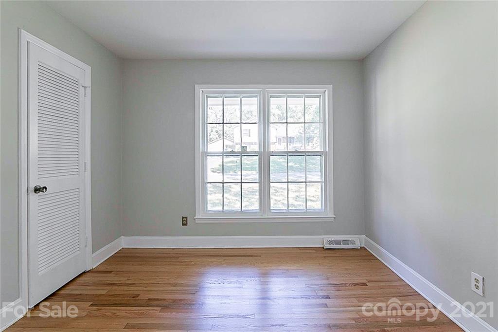 7410 Marlbrook Drive Charlotte, NC 28212 - Photo 11 of 16 an empty room with wooden floor and windows