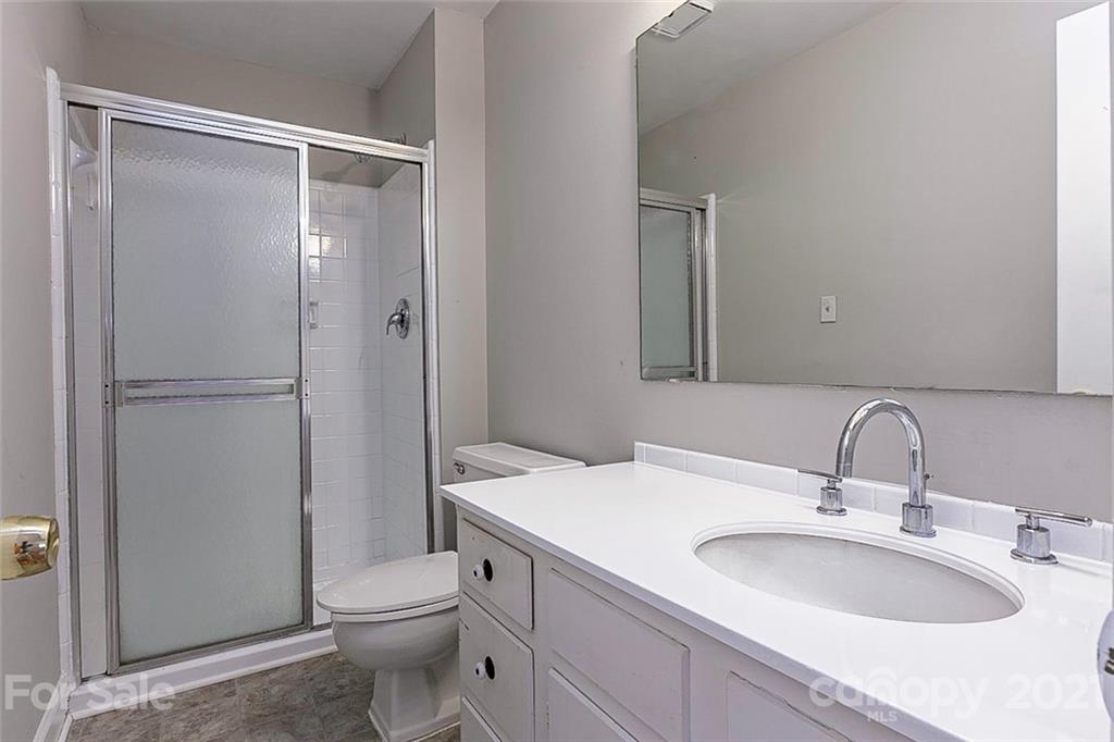 7410 Marlbrook Drive Charlotte, NC 28212 - Photo 13 of 16 a bathroom with a sink toilet and shower