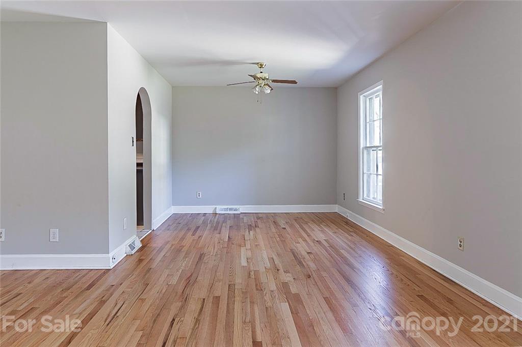 7410 Marlbrook Drive Charlotte, NC 28212 - Photo 5 of 16 wooden floor in an empty room with a window