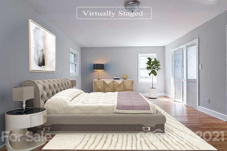 7410 Marlbrook Drive Charlotte, NC 28212 - Photo 9 of 16 a bedroom with a large bed and a wooden floor