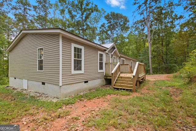 a wooden bench sitting in front of a house