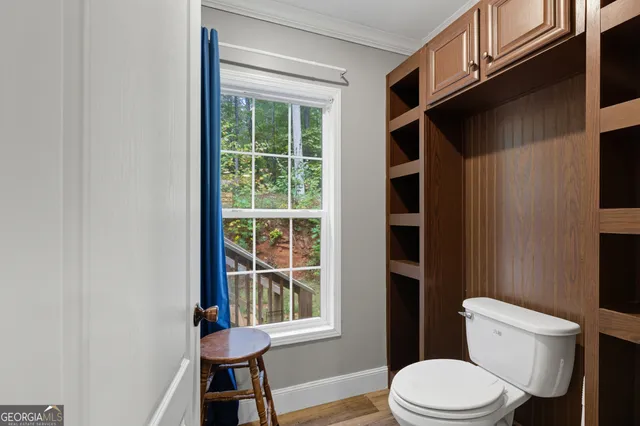 a white toilet sitting next to a window