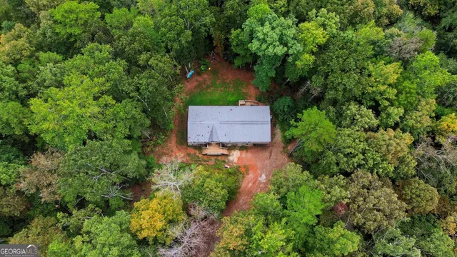 an aerial view of a house with a yard and garden